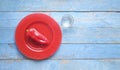 Red bell pepper on a red plate and a glass of water, dieting, healthy nutrion, fitness concept, flat lay Royalty Free Stock Photo