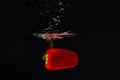 Red bellpepper falling into the water with splash Royalty Free Stock Photo