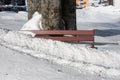 Red bench covered in snow, outdoors during daylight Royalty Free Stock Photo