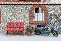 Red bench with flowers and motorcycle Royalty Free Stock Photo