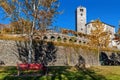 Old stone church and belfry tower under blue sky in autumn in Locarno, Switzerland. Royalty Free Stock Photo