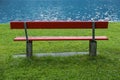 Red bench at lake shore Royalty Free Stock Photo