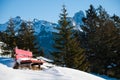 Red Bench in Snow, Background Austrian Alps Mountains Royalty Free Stock Photo