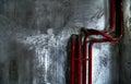 Red bent pipes on concrete walls