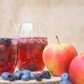 Delicious red berries Cocktail with blueberries in front of a blurred brown background