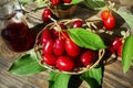 Red berries of cornel or dogwood with leaf ,and compote on a dark wooden