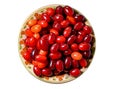 Red berries ripe dogwood in a clay plate.