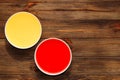 Red berry jelly and tropical yellow jelly in plates on the table.