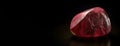 Red beryl is a rare precious natural stone on a black background. AI generated. Header banner mockup with space. Royalty Free Stock Photo