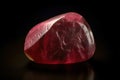 Red beryl is a rare precious natural stone on a black background. AI generated. Header banner mockup with space. Royalty Free Stock Photo