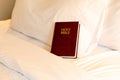 Bible on bed in hotel room