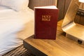 Bible in hotel room on bedside table