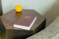 Bible in hotel room next to reading chair