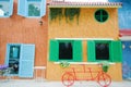 Red bicycle infront of colorful building