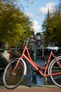 A bicycle parked on a bridge over an Amsterdam canal Royalty Free Stock Photo