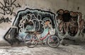 A red bicycle is parked beside the graffiti patterns on the wall Royalty Free Stock Photo