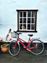 Red Bicycle under a window Royalty Free Stock Photo