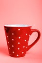 Red big cup in white small peas Royalty Free Stock Photo