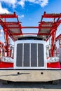 Red big rig semi truck with two level modular car hauler semi trailer waiting for the next load standing on the dealer parking lot Royalty Free Stock Photo