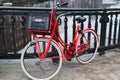 Red bike on bridge over gracht canal, Amsterdam