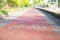 Red Bike lane asphalt texture with sunlight Royalty Free Stock Photo