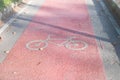 Red Bike lane asphalt texture with sunlight Royalty Free Stock Photo