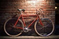 Red bike leaning against building brick wall in city street, created using generative ai technology Royalty Free Stock Photo