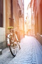 Red bike on the old narrow street. Morning sunshine Royalty Free Stock Photo