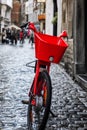 Red bike on the street of the old city. Health and ecology. Vertical