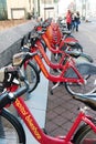 Red bikes stand in a row at the rental site