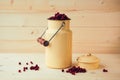 Red bilberry, cowberry, fowberry, redberry. Cranberry in can on wooden background