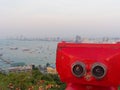 Red binocular on Pattaya beach showing explore and discover new place in tourism industry Royalty Free Stock Photo