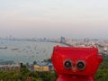 Red binocular on Pattaya beach showing explore and discover new place in tourism industry Royalty Free Stock Photo