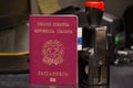 Red biometric passport of a Italian citizen with a border date stamper, close-up. Inscription - European Union, Italian Republic,