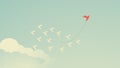 Red bird changing direction and white ones. New idea, change, trend, courage, creative solution,business, innovation and unique Royalty Free Stock Photo