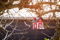 Red birdhouse barn hanging in a tree Royalty Free Stock Photo
