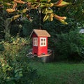 A red birdhouse in the green Royalty Free Stock Photo