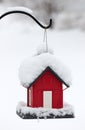 Red Birdhouse in the White Snow