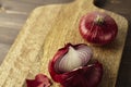 Red bisect onion on wooden table. Close-up from above.