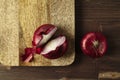 Red bisect onion on wooden table. Close-up from above.
