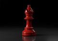 Red bishop chess, standing against black background