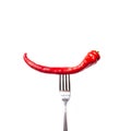 Red bitter chili pepper on the fork on white isolated background. Creative Food concept Royalty Free Stock Photo