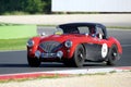 Red/Black Austin Healey 100/4 BN1, 1954, drives in the Autodromo di Vallelunga during 1000 Miglia Royalty Free Stock Photo