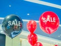 Red and black balloons with white inscription SALE under the ceiling of the mall Royalty Free Stock Photo