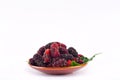 Red and black berry fruit and mulberry leaf in brown bowl on white background healthy mulberry fruit food isolated Royalty Free Stock Photo