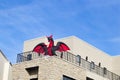 Red and Black blow up dragon on balcony of business building against blue sky for Halloween Royalty Free Stock Photo