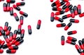 Red-black capsule pills spread on white background. Antibiotic drug use with reasonable. Pharmaceutical industry. Pharmacy Royalty Free Stock Photo