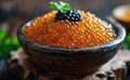Red and black caviar in bowl on wooden table Royalty Free Stock Photo