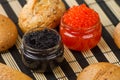 Red and black caviar in a jar with bread Royalty Free Stock Photo