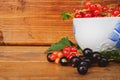 Red and black currants in a white mug on a wooden background Royalty Free Stock Photo